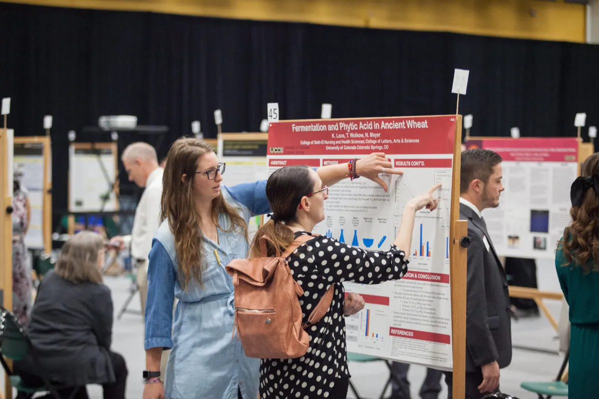 graduate student at research fair on campus